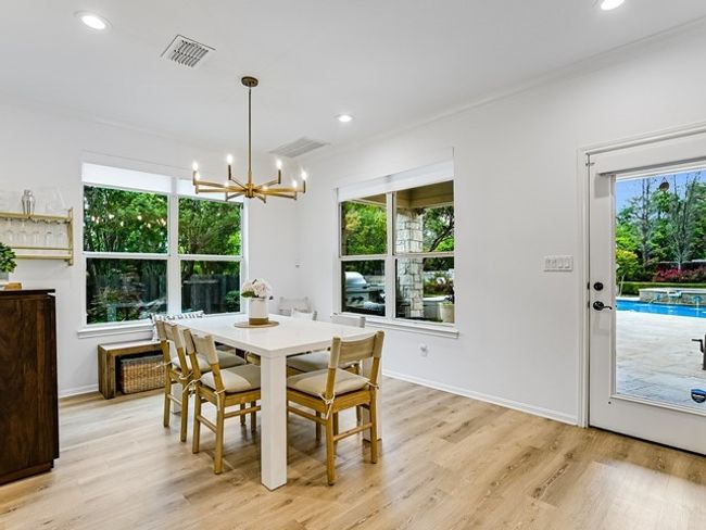 Dining room with visible vents, light wood-type flooring, recessed lighting, and a notable chandelier | Image 11