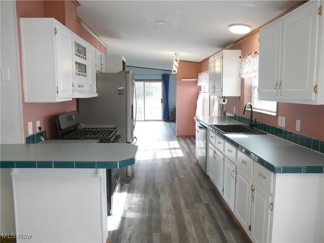 Kitchen featuring white cabinets, and stainless steel appliances | Image 6