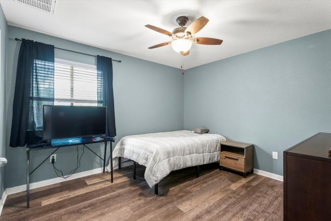 Bedroom featuring wood finished floors, baseboards, and a ceiling fan | Image 20