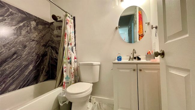 Bathroom featuring vanity and shower / bath combo | Image 9