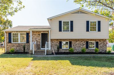 Split level home featuring a front yard | Image 1