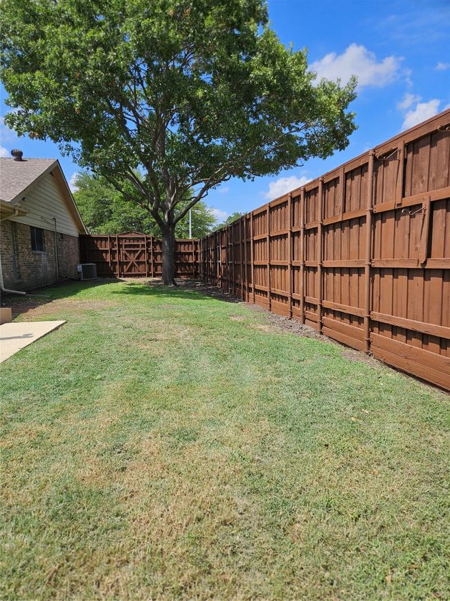 View of fenced backyard | Image 17