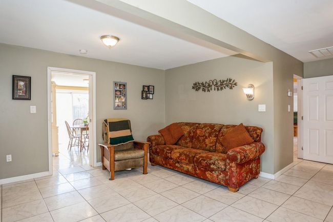 Living room with baseboards and visible vents | Image 10