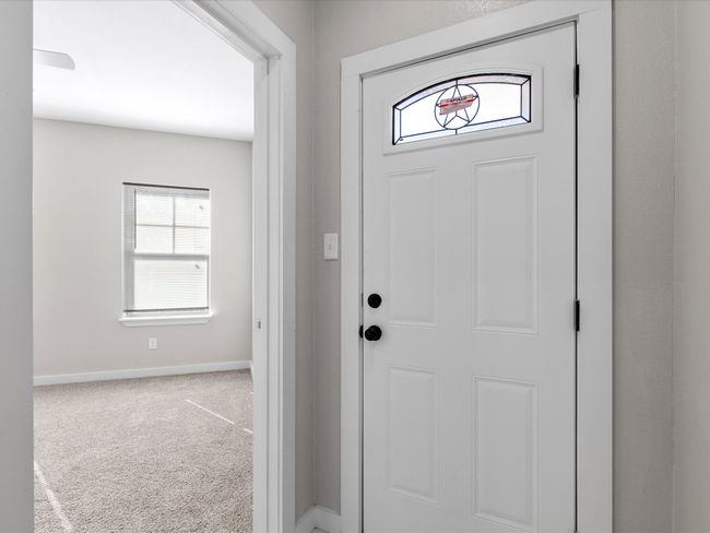 Carpeted entrance foyer featuring baseboards | Image 23
