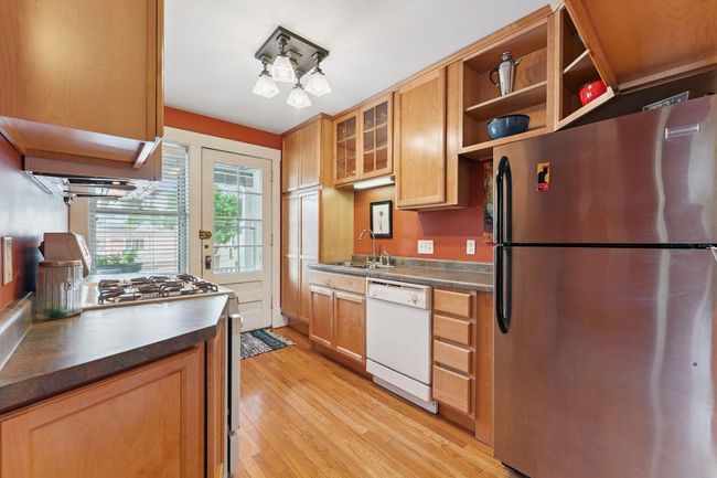 This updated, sunny kitchen has great storage | Image 25