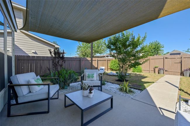 View of patio with a gate, outdoor lounge area, and a fenced backyard | Image 35