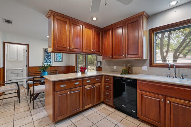 The opening off the casual dining area leads to a Butler's pantry with sink, cabinets and pantry storage | Image 18