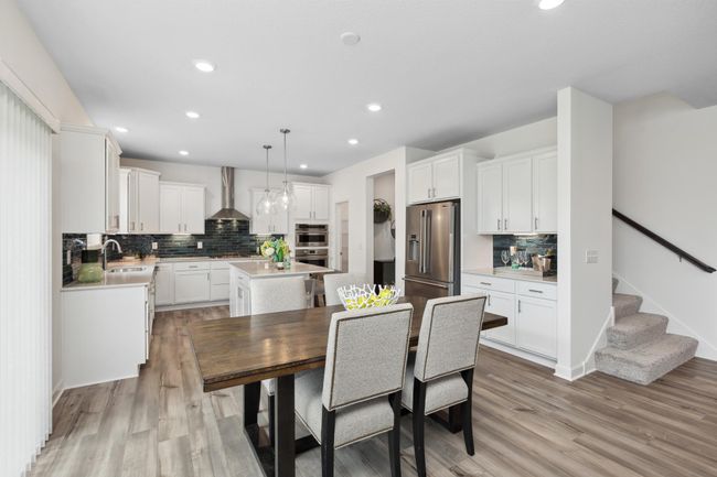 Photo is of the actual model. Soaked in natural sunlight, the homes eat-in dining room has ample space for a dining table located in the heart of the home. | Image 5