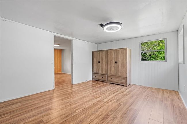 Unfurnished bedroom with light wood finished floors and baseboards | Image 19