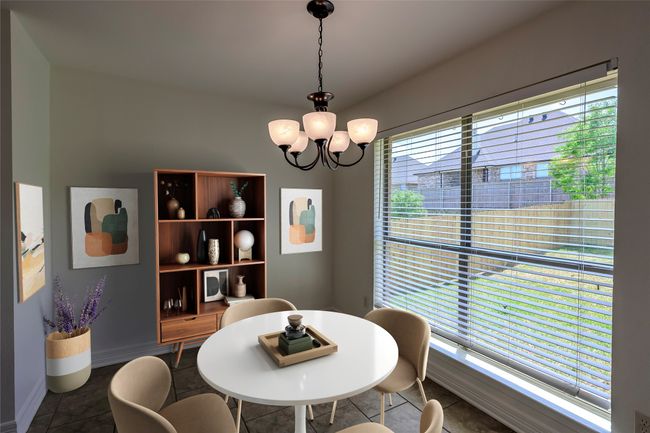 Dining area with tile patterned floors and an inviting chandelier | Image 4