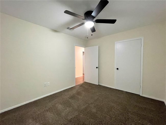 Unfurnished bedroom featuring dark carpet and a ceiling fan | Image 22