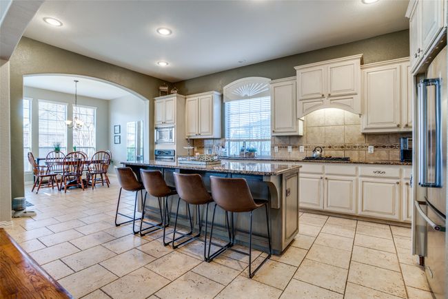 Large kitchen with granite, kitchen island, stainless steel appliances | Image 11