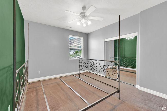 Carpeted bedroom featuring visible vents, baseboards, and ceiling fan | Image 34