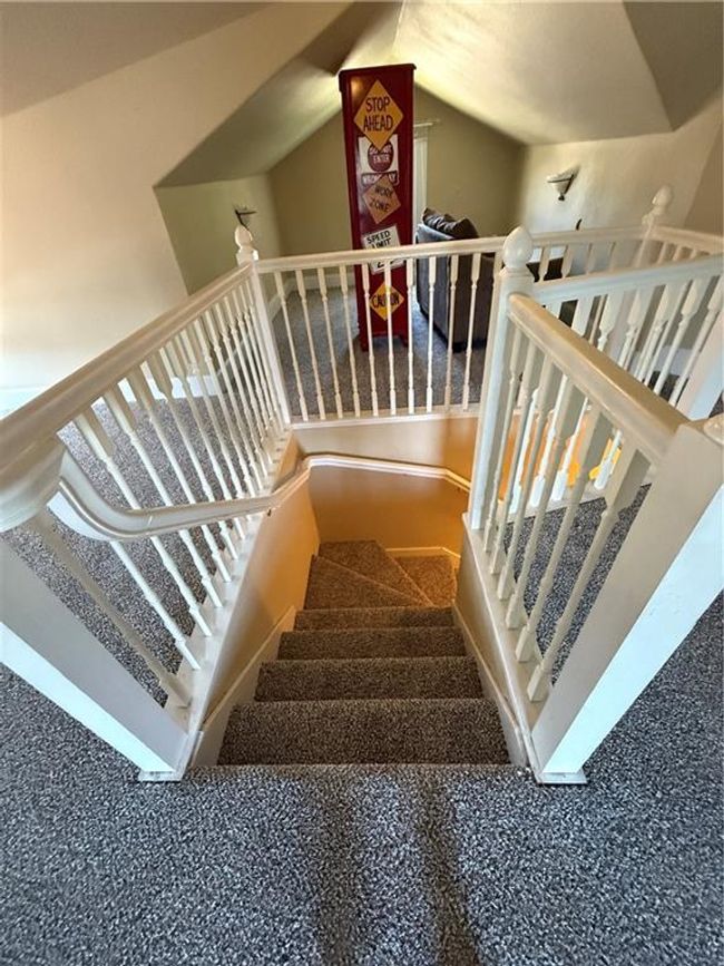 Stairs featuring vaulted ceiling | Image 34
