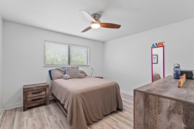Bedroom featuring light wood-style flooring, baseboards, and ceiling fan | Image 24