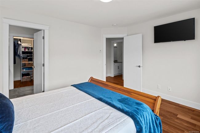 Bedroom with wood finished floors, a walk in closet, and a closet | Image 36