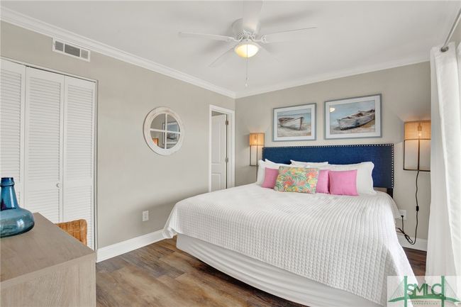 Primary Bedroom with En-Suite Bathroom & Sliding Glass Door leading to Spacious Balcony with Pool View | Image 18