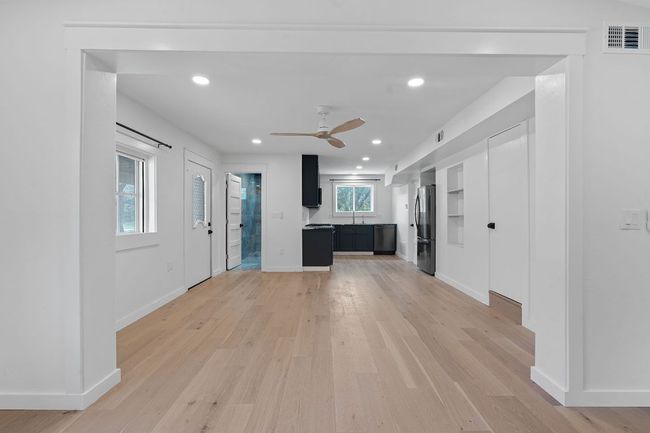 Unfurnished living room featuring ceiling fan, light wood-style floors, and recessed lighting | Image 7