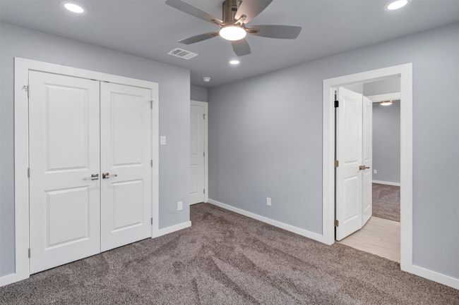 Unfurnished bedroom featuring carpet floors, recessed lighting, a closet, and a ceiling fan | Image 32