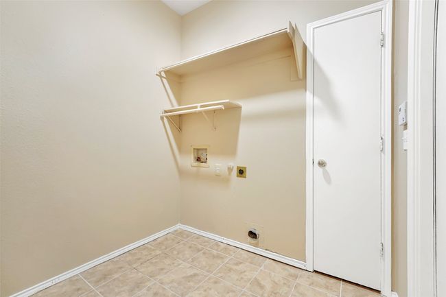 Laundry area with hookup for a washing machine, hookup for an electric dryer, and light tile floors | Image 36
