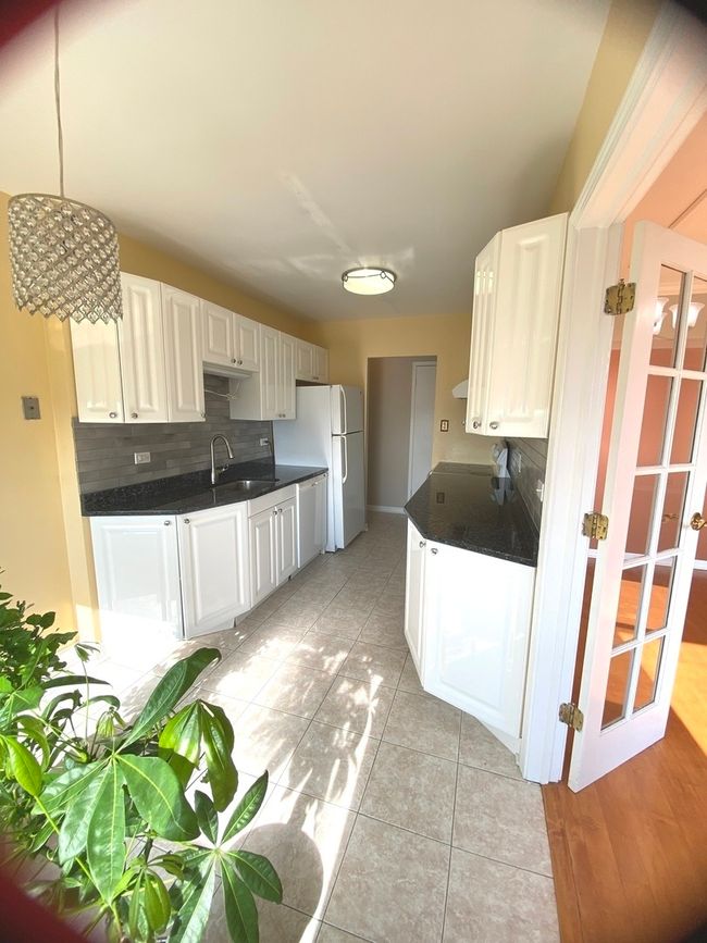 Galley style kitchen, white appliances | Image 14