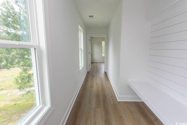 Hallway featuring drop zone, wood finished floors, natural light, and baseboards | Image 16