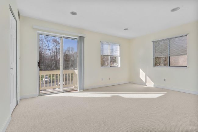Primary Bedroom with new carpet and access to deck | Image 19