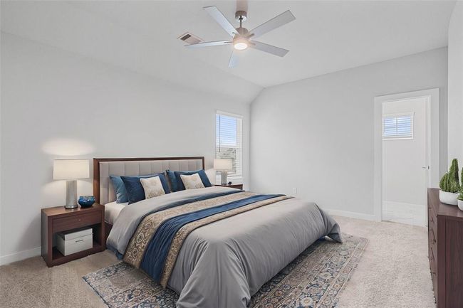 Secondary bedroom features plush carpet, custom paint, ceiling fan with lighting and a large window with privacy blinds. | Image 19