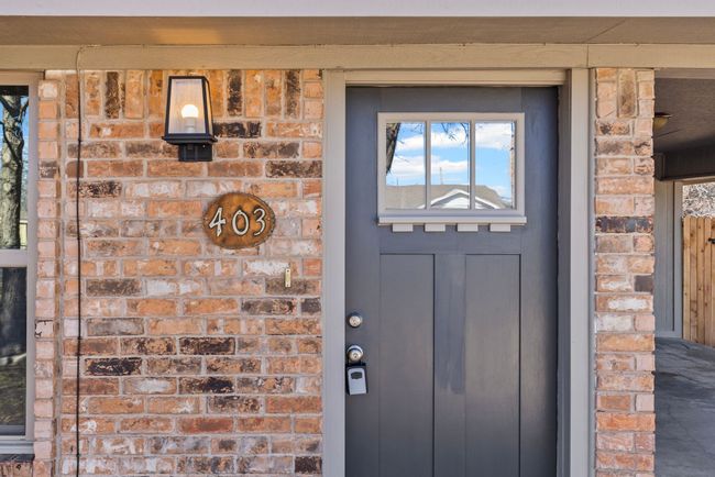 View of exterior entry with brick siding | Image 4