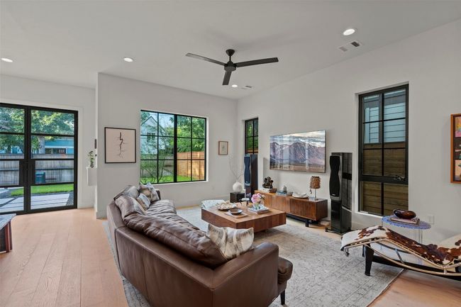 Living room with light wood finished floors, recessed lighting, and ceiling fan | Image 8