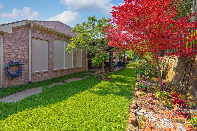 Backyard featuring stepping pavers, garden beds, and patio. | Image 29
