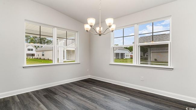 Spare room featuring a healthy amount of sunlight and dark hardwood / wood-style floors | Image 17
