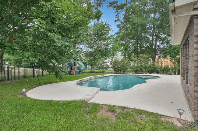 Lush landscaping and tree coverage make this a true backyard oasis. | Image 41