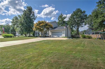 View of front facade with a garage, a playground, and a front yard | Image 3