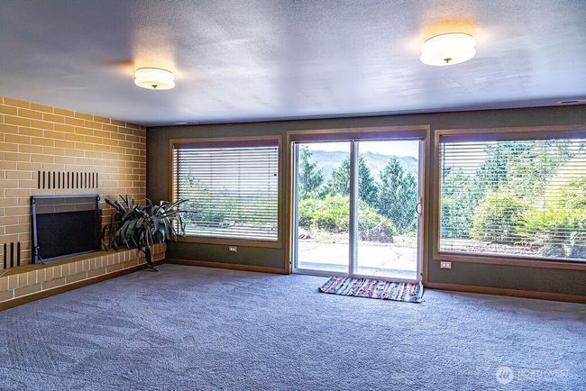 Another wood burning fireplace in rec room. Slider leads to the back yard. | Image 16