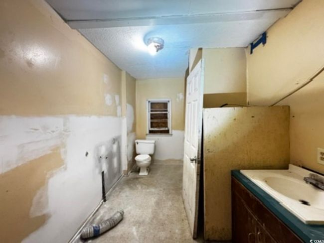 Bathroom with vanity and unfinished concrete floors | Image 18