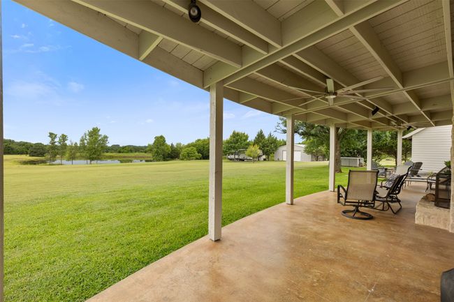 View of patio / terrace with a water view and a ceiling fan | Image 28