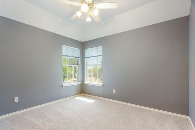 Unfurnished room with carpet, baseboards, and a ceiling fan | Image 20