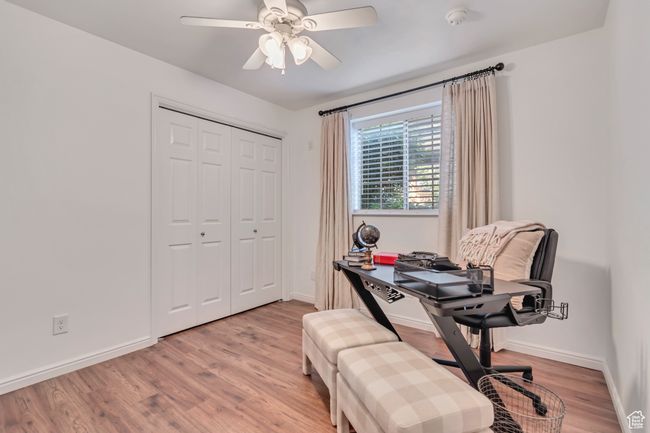 Home office featuring wood finished floors, ceiling fan, and baseboards | Image 14