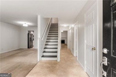 Main level living area complete with den, dining, kitchen, storage and half bath. | Image 2