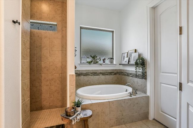 Bathroom with a walk in shower, tile patterned flooring, and a garden tub | Image 21