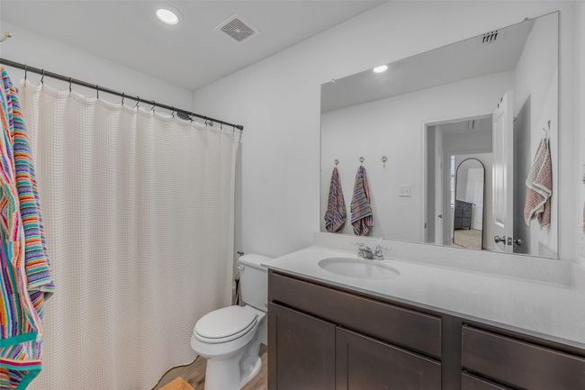 Full bathroom with vanity, recessed lighting, and a shower with shower curtain | Image 24