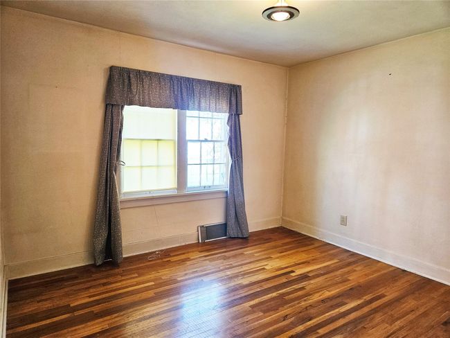 Unfurnished room featuring baseboards and wood finished floors | Image 14