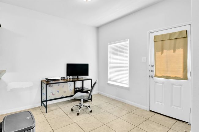 Office space with light tile patterned floors and baseboards | Image 10