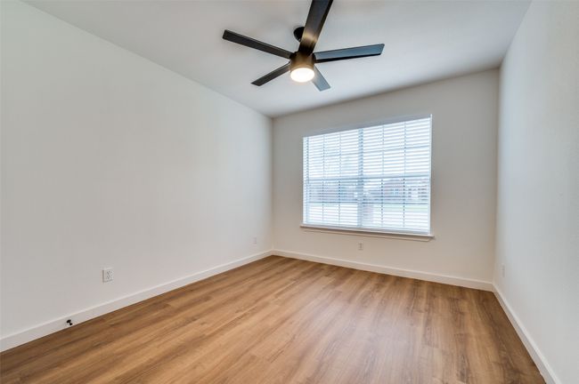 Empty room featuring ceiling fan, baseboards, and wood finished floors | Image 17