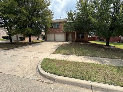 View of front of property with a front lawn and a garage | Image 1