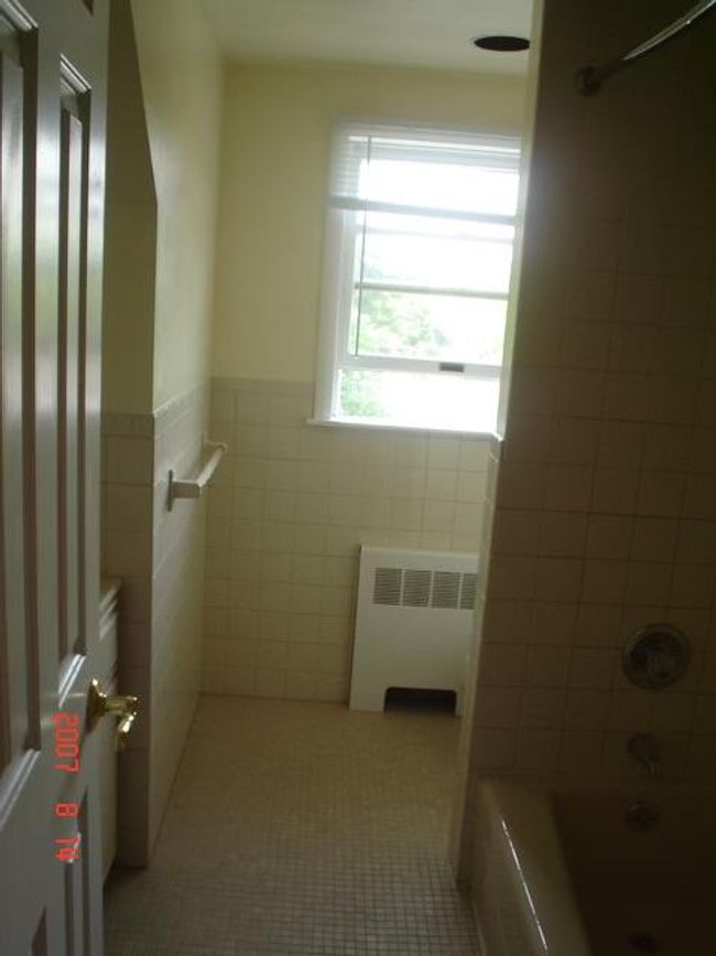 2nd Fl Bathroom featuring tiled shower / bath combo, radiator, tile walls, and tile patterned floors | Image 11