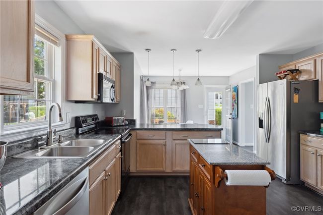 The Kitchen has beautiful laminate counters and the refrigerator conveys! | Image 16