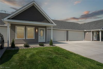 View of front of house featuring garage and a lawn | Image 1