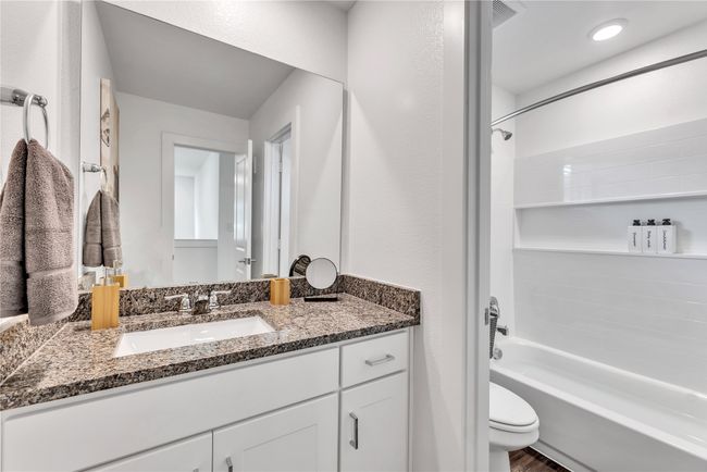 Full bathroom featuring shower combination, vanity, and toilet | Image 16